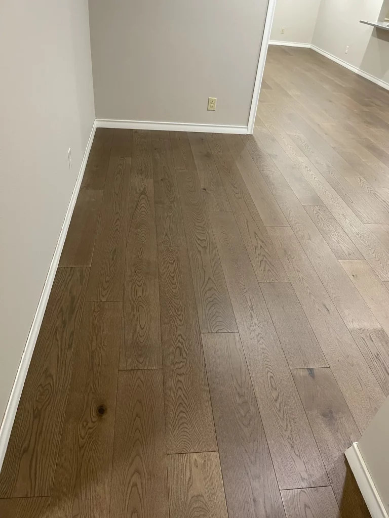 The same entry hall with light wide-plank white oak laid along its length