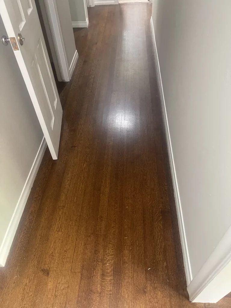Entry hall with narrow dark oak boards running the length of the hallway
