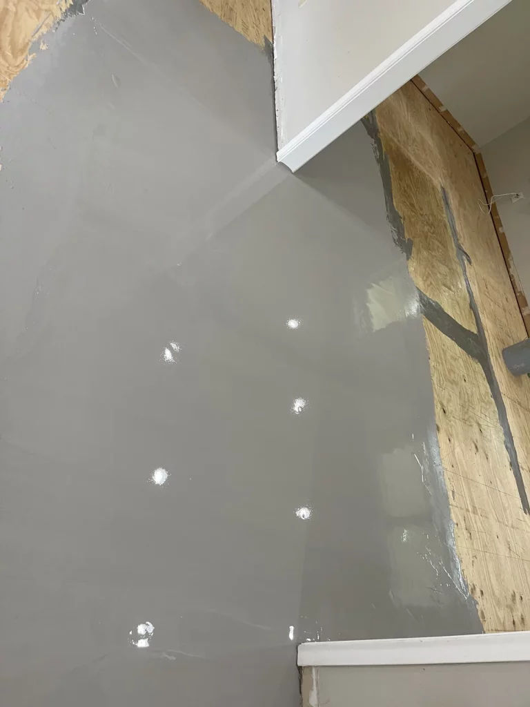 Self-levelling underlayment poured over the prepared plywood subfloor